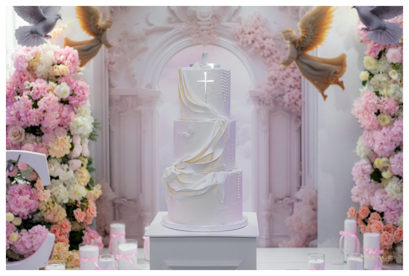 Elegant dop med tårta, änglar och ljus Elegant och väl dekorerat dop med tårta, änglar och ljus, professionellt fotograferat i en varm och stämningsfull miljö. Foto - Vamale Photo